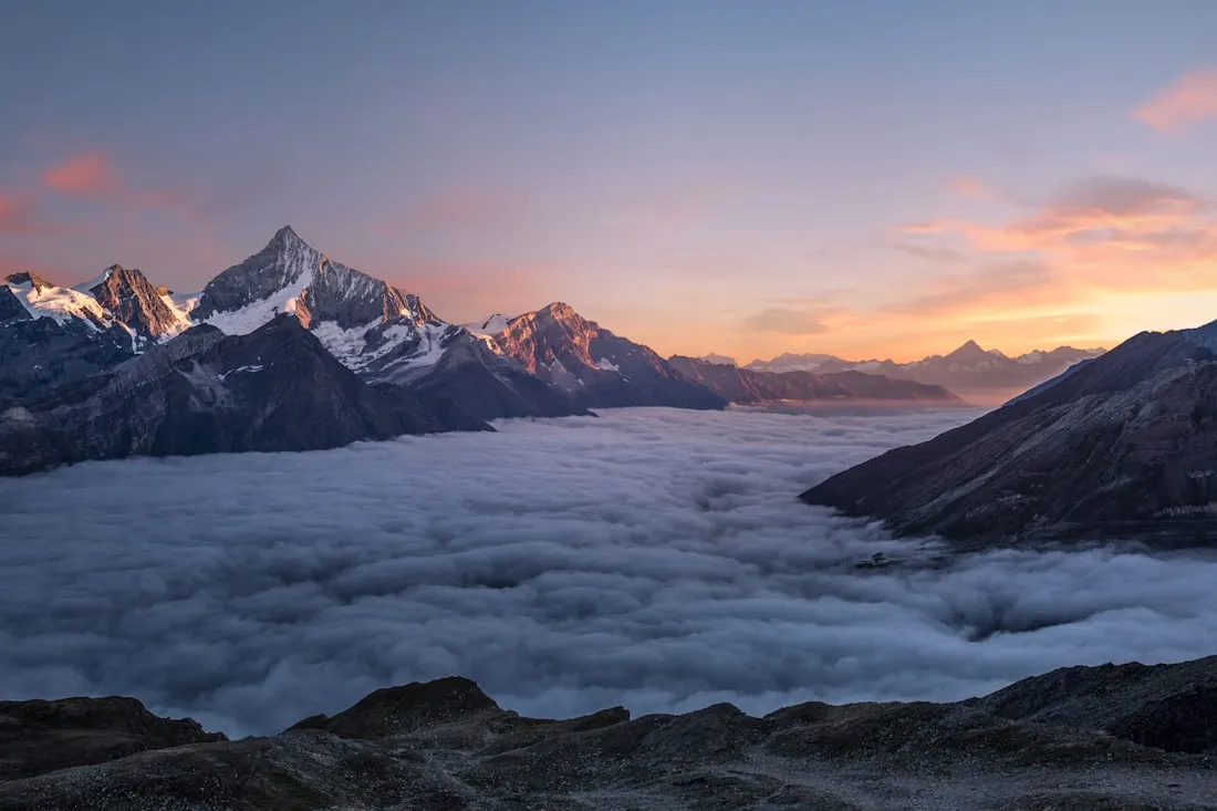 Soft sunrise light over misty mountains