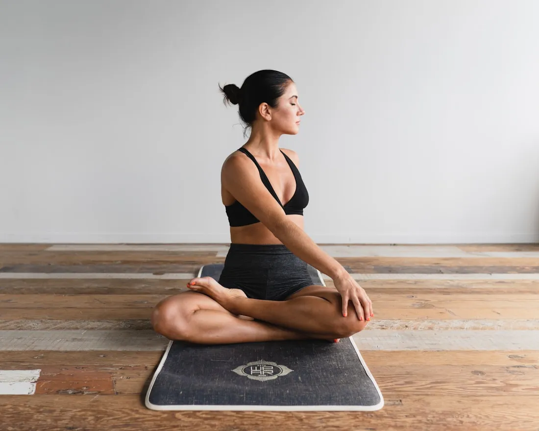 A person sitting in quiet meditation on a mat